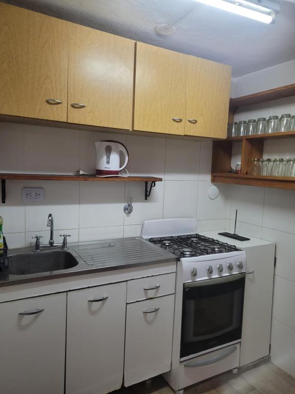 a kitchen with a stove and a sink at Quinta El Reencuentro tu refugio en Campana in Campana