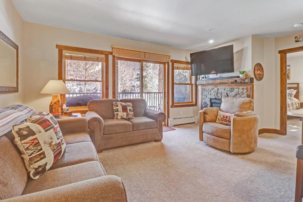 a living room with a couch and a fireplace at CS110 Copper Springs condo in Copper Mountain