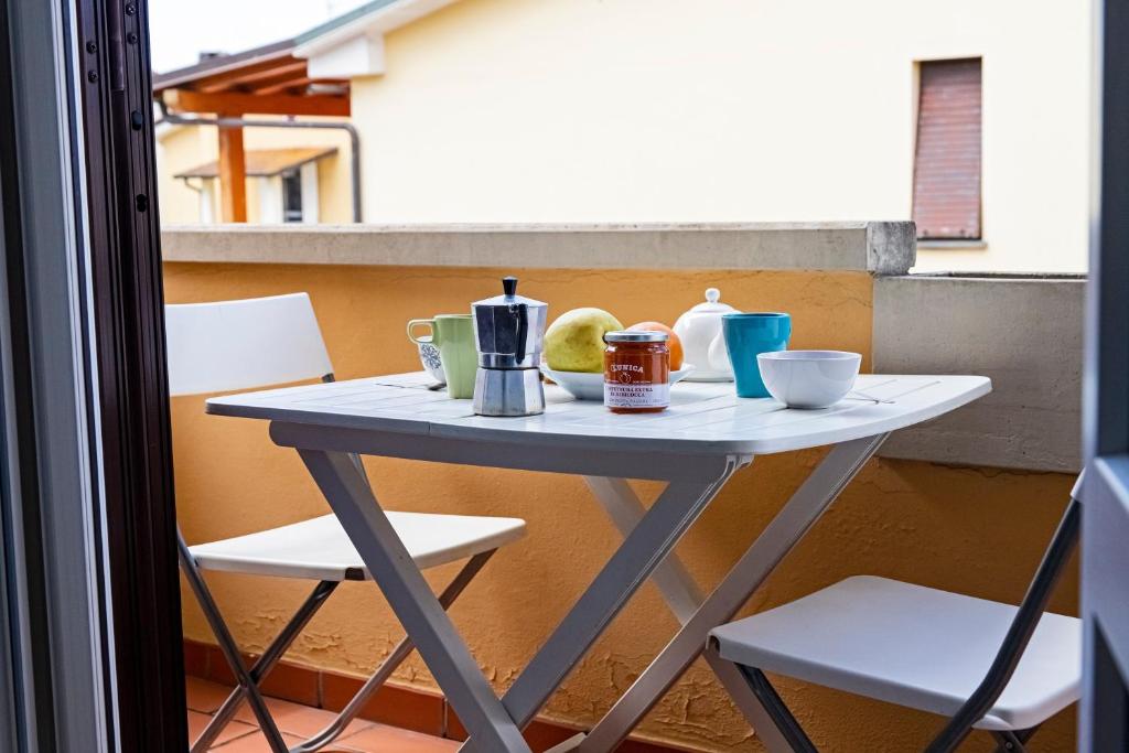a table sitting on a balcony with two chairs at Raggio di Sole in Torre del Lago Puccini