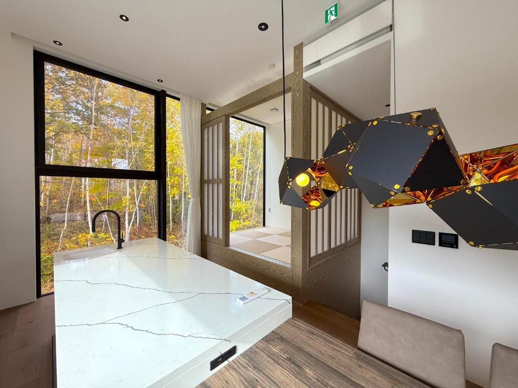 a kitchen with a sink and a counter top at The Fount Niseko in Niseko
