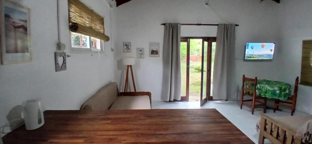 a living room with a wooden table and a couch at Chalet La Gran Familia in San Bernardo