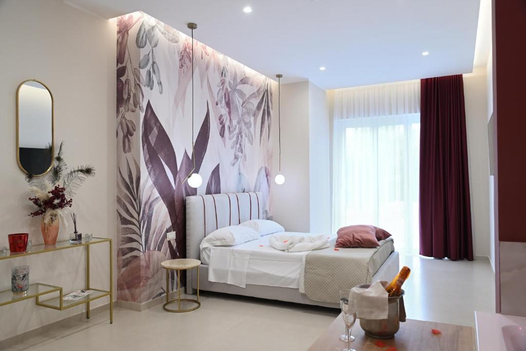 a bedroom with a bed and a large window at Baffone Hotel in Castel Volturno