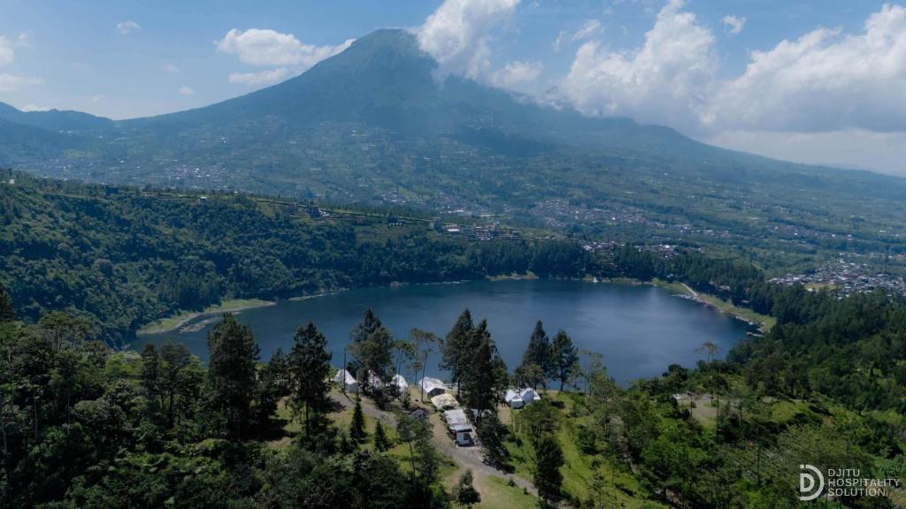an aerial view of a lake with a mountain at Fortune Glamping in Dieng