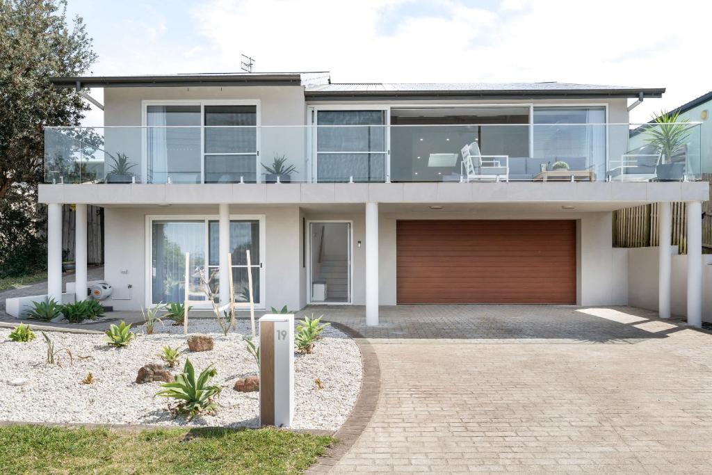 a large house with a garage in front of it at Thalassa Views Ulladulla in Ulladulla