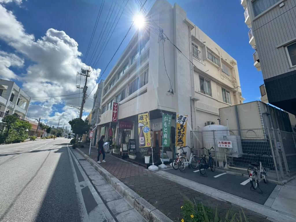 a building on a street with bikes parked next to it at Southern Gate HIVE in Ishigaki Island