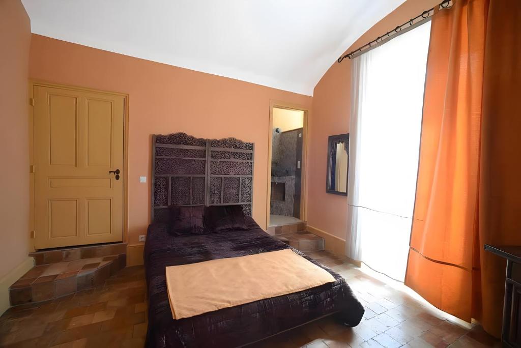 a bedroom with a bed and a large window at Chambre d'hôte la Ronce in Saint-Germain