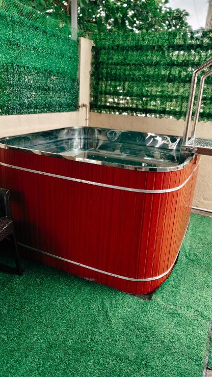 a hot tub in the middle of a room with green grass at 2G's Staycation Home in San Felix