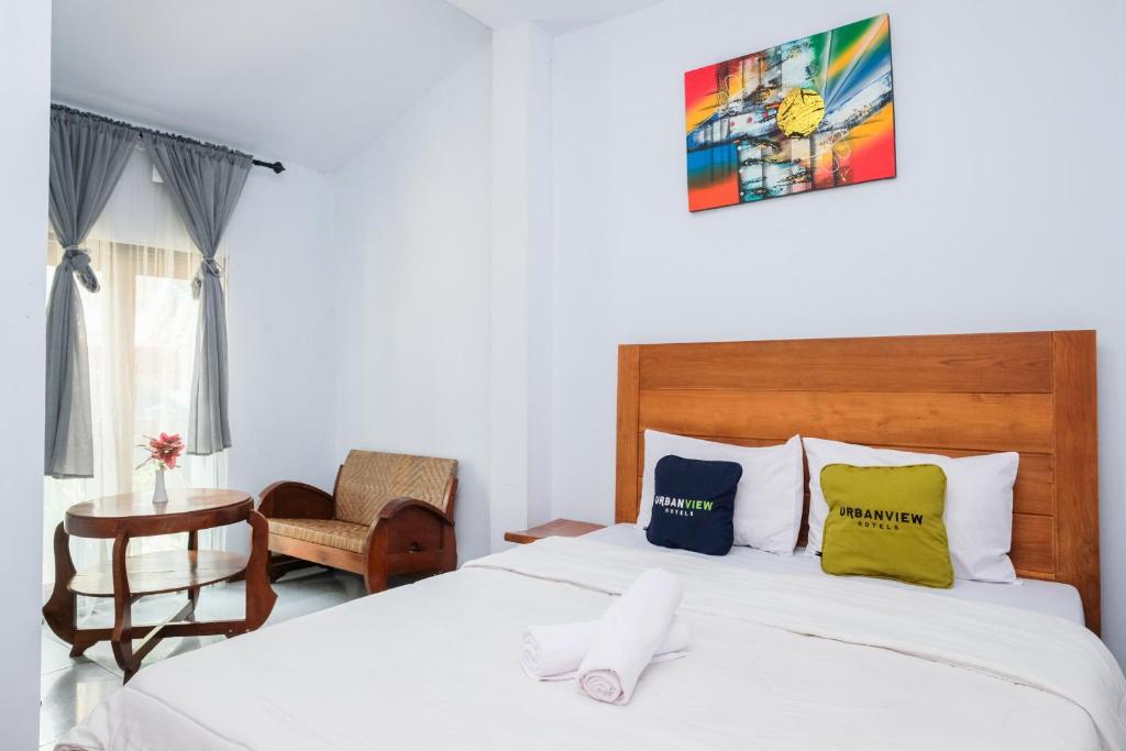 Ένα ή περισσότερα κρεβάτια σε δωμάτιο στο Urbanview Hotel Tan Jokteng Prawirotaman