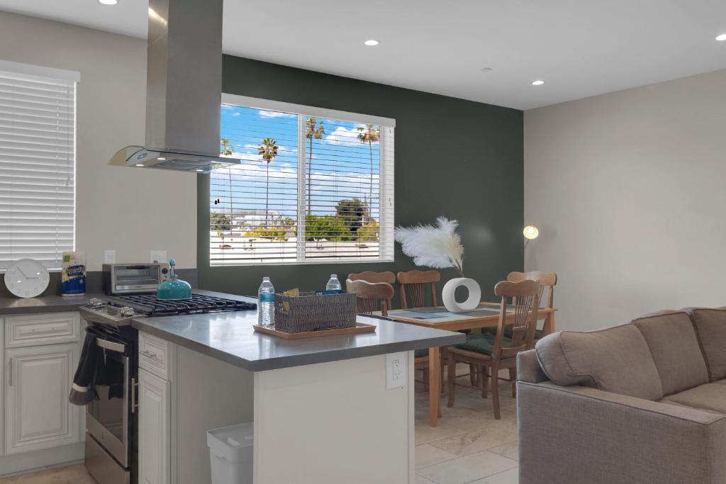 a kitchen with a counter top and a kitchen with a table at Serenity Condos With Mountain Views in Los Angeles