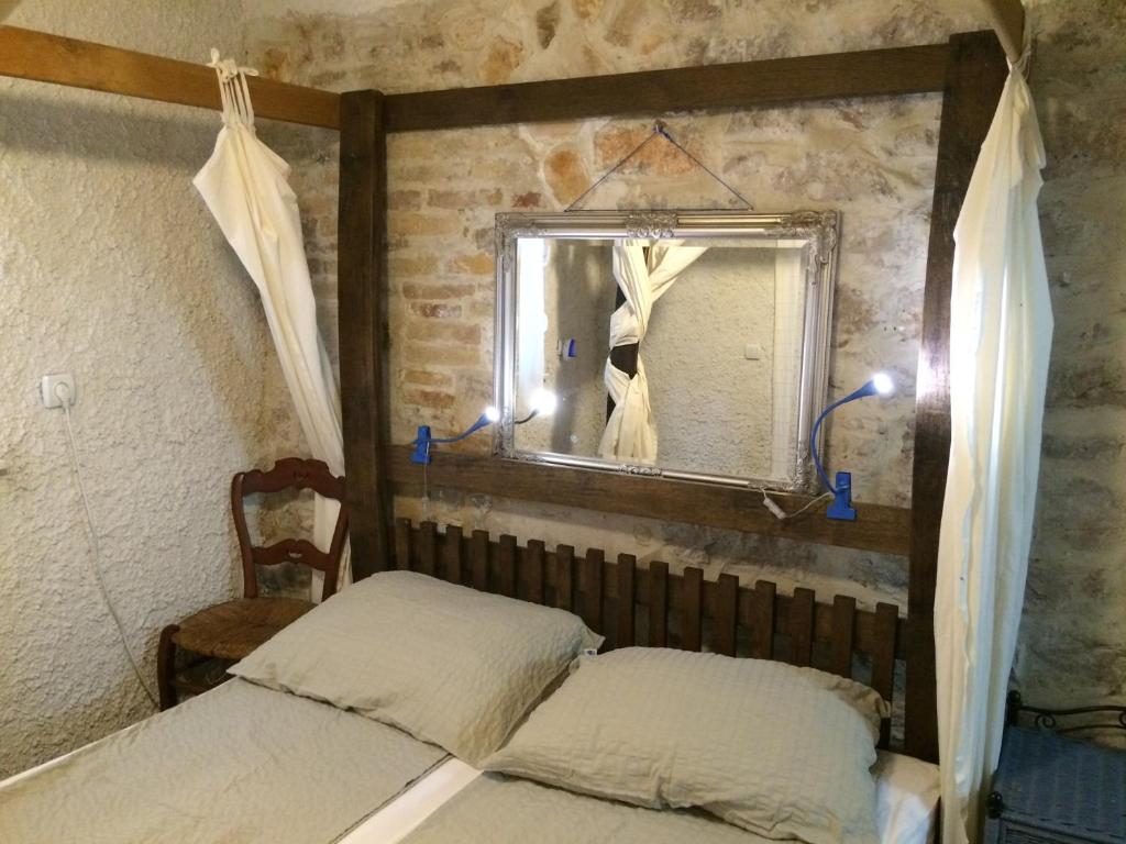 a bedroom with a bed and a mirror at Apartments Voltera parking space near the house in Betina