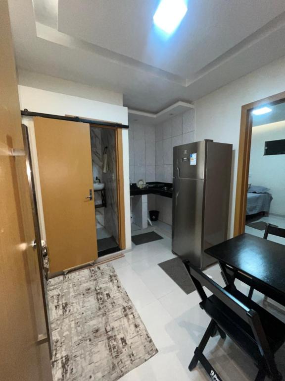 a kitchen with a refrigerator and a table in a room at Casa completa no centro de Belém in Belém