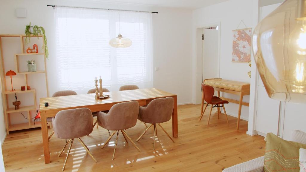 a dining room with a wooden table and chairs at Boho Chic in Germering