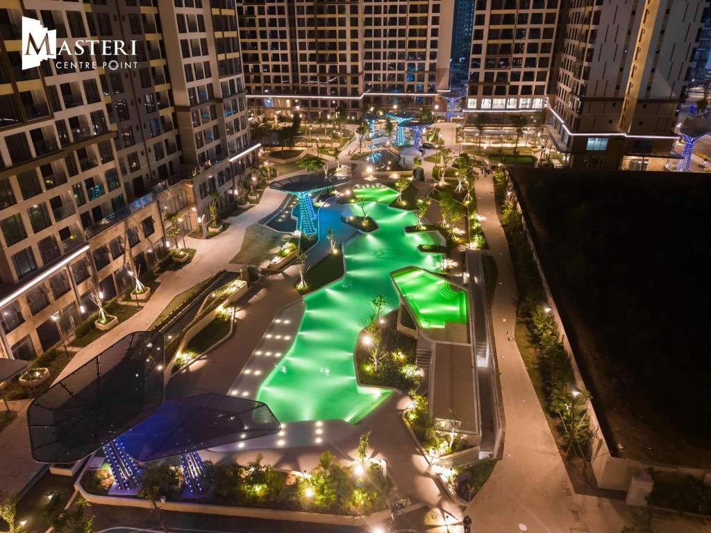an aerial view of a pool in a city at night at 2BR Cozy Apartment- River and Park View- Masteri Centre Point - HCM in Ho Chi Minh City