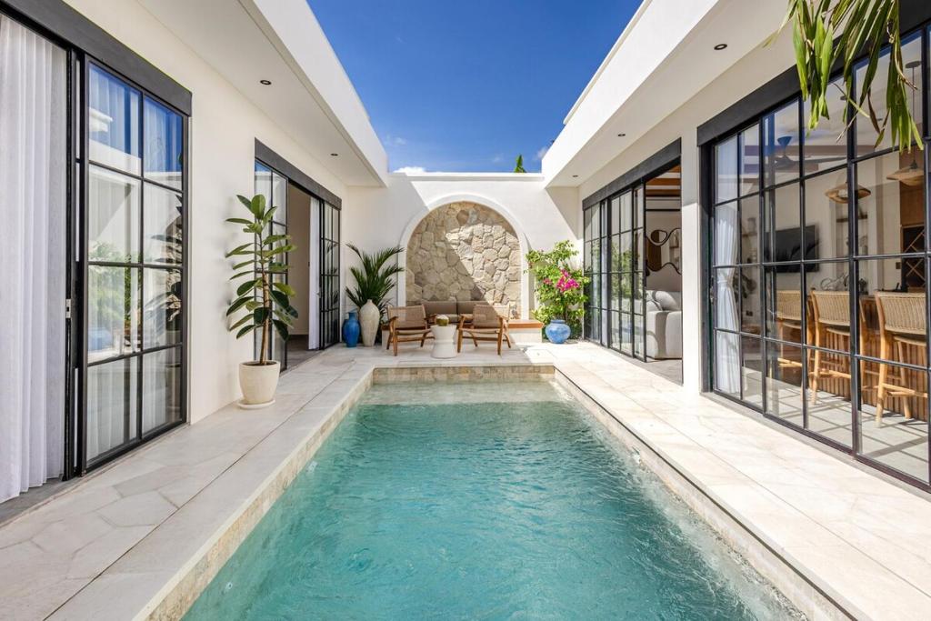 an exterior view of a house with a swimming pool at Villa Nida Premium by Tofino Villas in Uluwatu