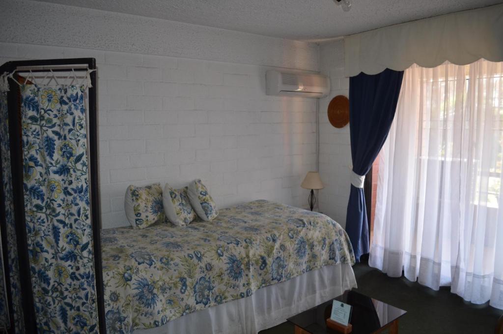 Postel nebo postele na pokoji v ubytování Apart Hotel Punto Real