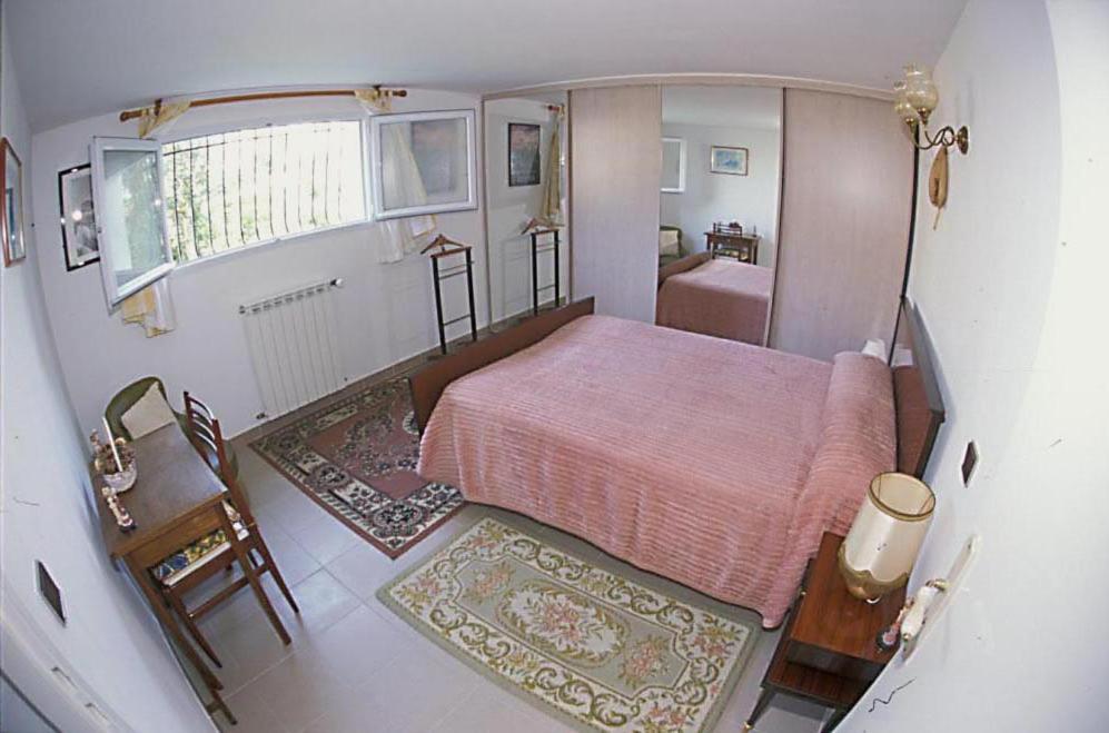 a small bedroom with a bed and a bathroom at L'Hernani in Capbreton