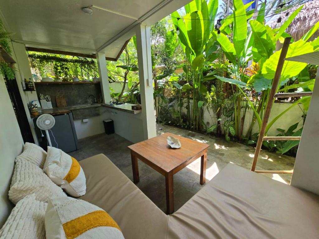 a living room with a couch and a table at Little house in El Nido