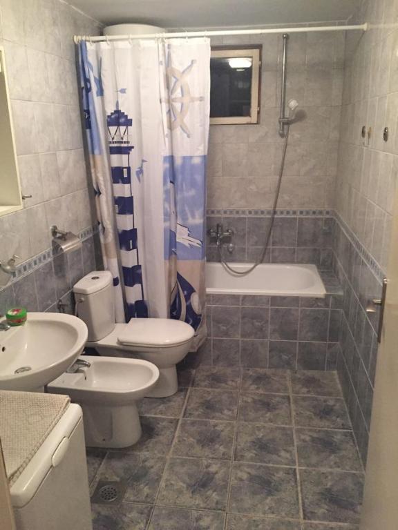 a bathroom with a shower and a toilet and a sink at Apartmani Perić in Bar