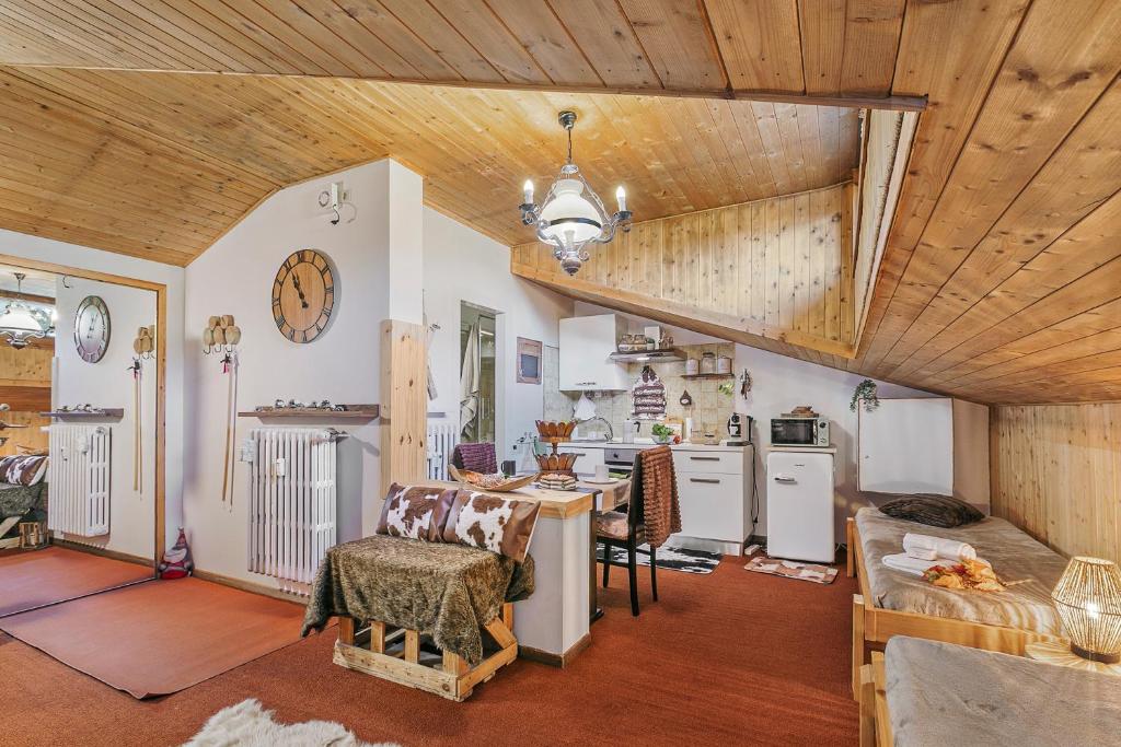 a kitchen with white appliances and a wooden ceiling at Studio Valleverde 33B Ski in Ski Out - Happy Rentals in Sestriere