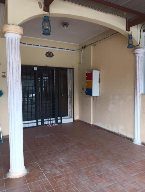 an empty room with columns and a door at CD Homestay 