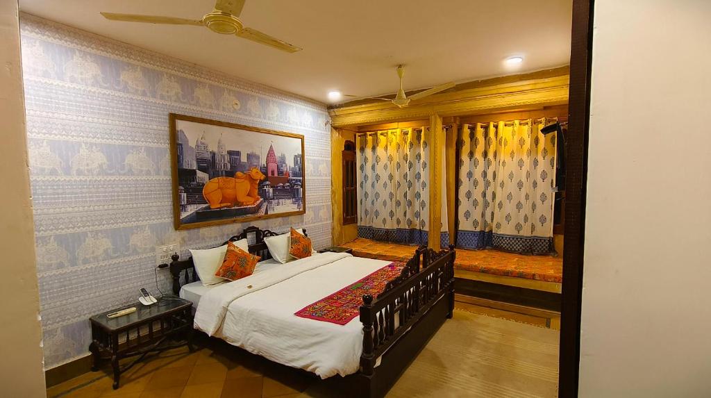 a bedroom with a bed and a window at Kiran Apartment By Experience Jaisalmer in Jaisalmer