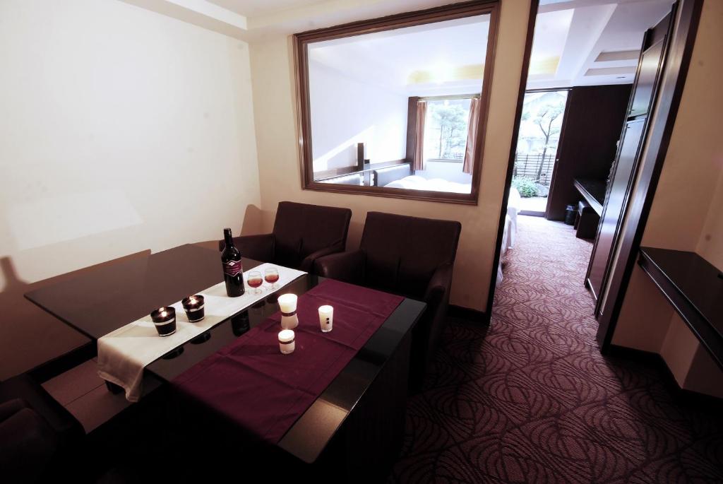 a room with a table and chairs and a window at The Enterpriser Hotel in Taichung