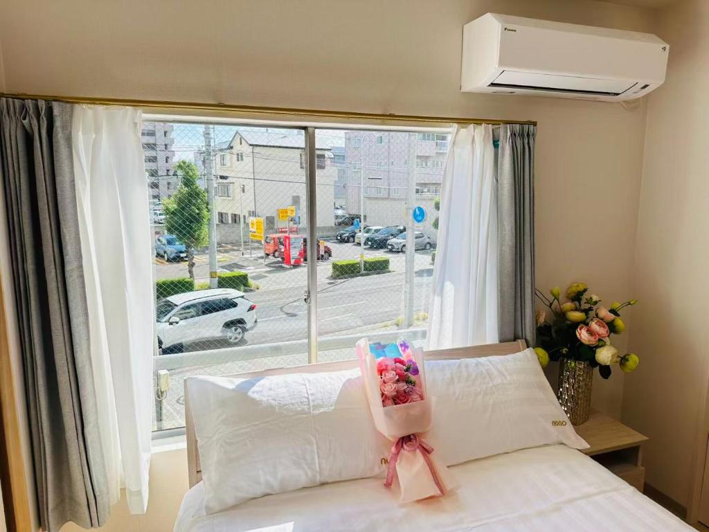a bedroom with a bed and a large window at Nono in Takamatsu