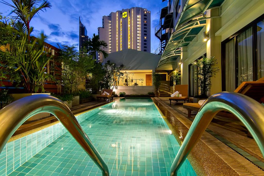 ein Schwimmbad in der Mitte eines Gebäudes in der Unterkunft Bossotel Bangkok in Bangkok