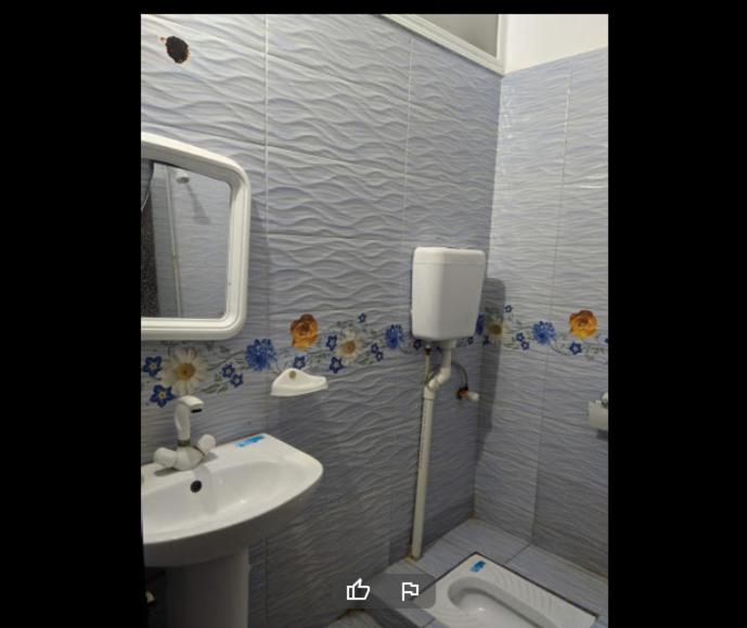 ein Badezimmer mit Waschbecken und Spiegel in der Unterkunft High City Hotel in Dargai