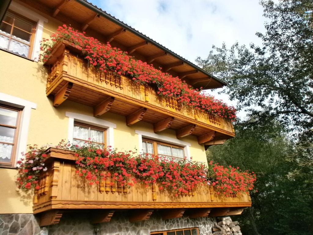 ein Gebäude mit roten Blumen auf dem Balkon in der Unterkunft Penzión Stefanshof in Kremnitz