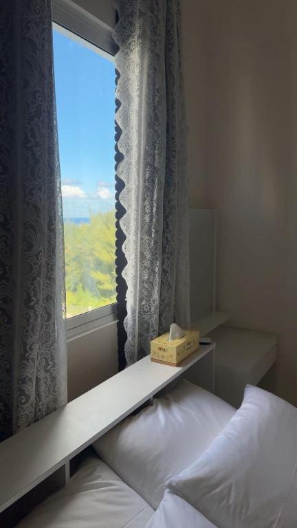 a bedroom with a bed and a window with a box on it at STO Tower A Hulhumale Phase 2 in Hulhumale