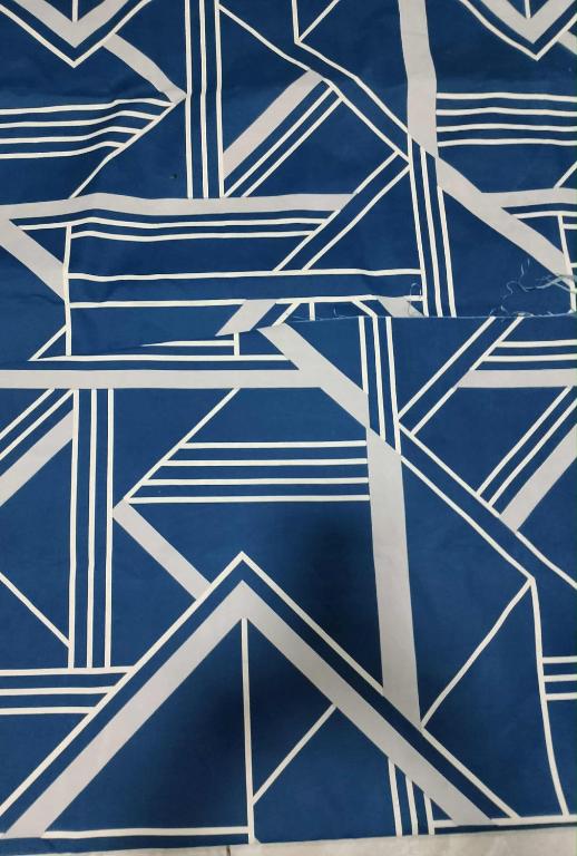 a blue and white tile pattern on a wall at burgos in San Isidro