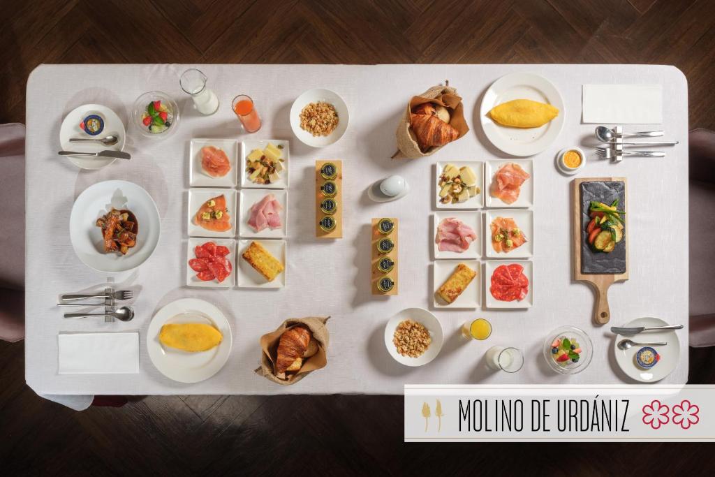 a table with different dishes of food on it at Hotel Mvsa+Michelin 2 Starred Molino de Urdàniz in Taipei