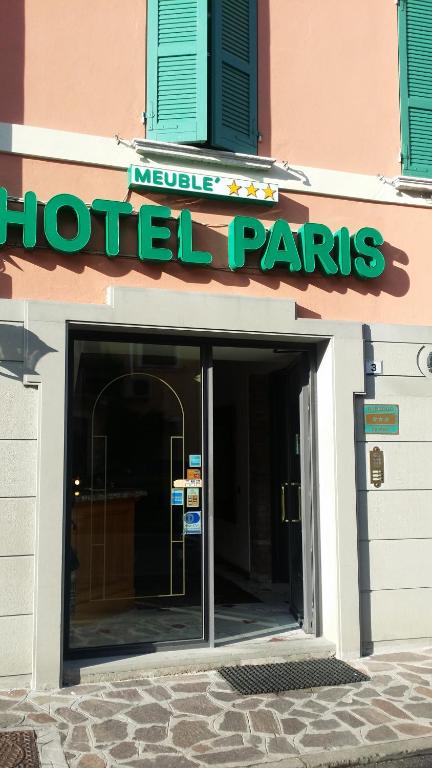 a hotel entrance with a sign on a building at Hotel Paris in Castel Goffredo