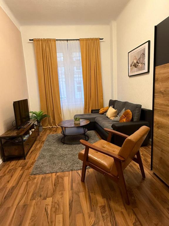 a living room with a couch and a table at Eigentumswohnung in Dresden in Dresden