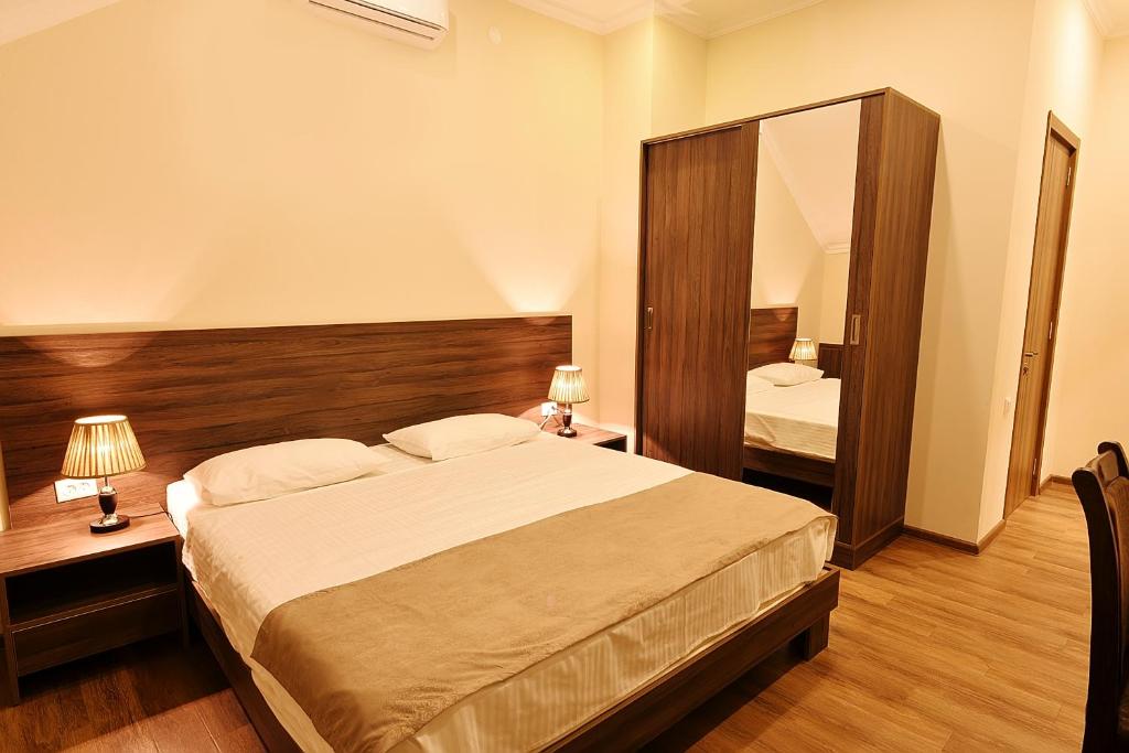 Postel nebo postele na pokoji v ubytování MGK Hotel