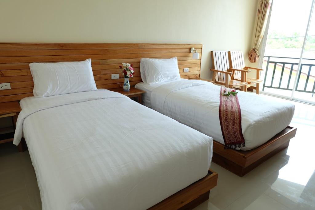 Postel nebo postele na pokoji v ubytování Chatin Guesthouse