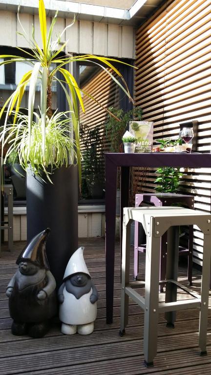 a patio with a table and a table and plants at Campanile Nancy Centre - Gare in Nancy