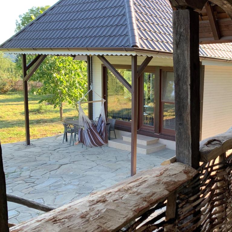 a screened in porch with a metal roof at La Brebu 102 in Brebu Mînăstirei