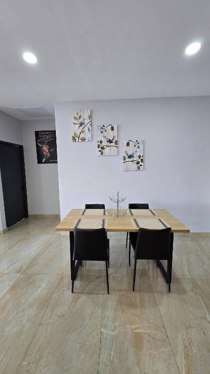 a dining room with a table and two chairs at La Parada House 25 in Concepción