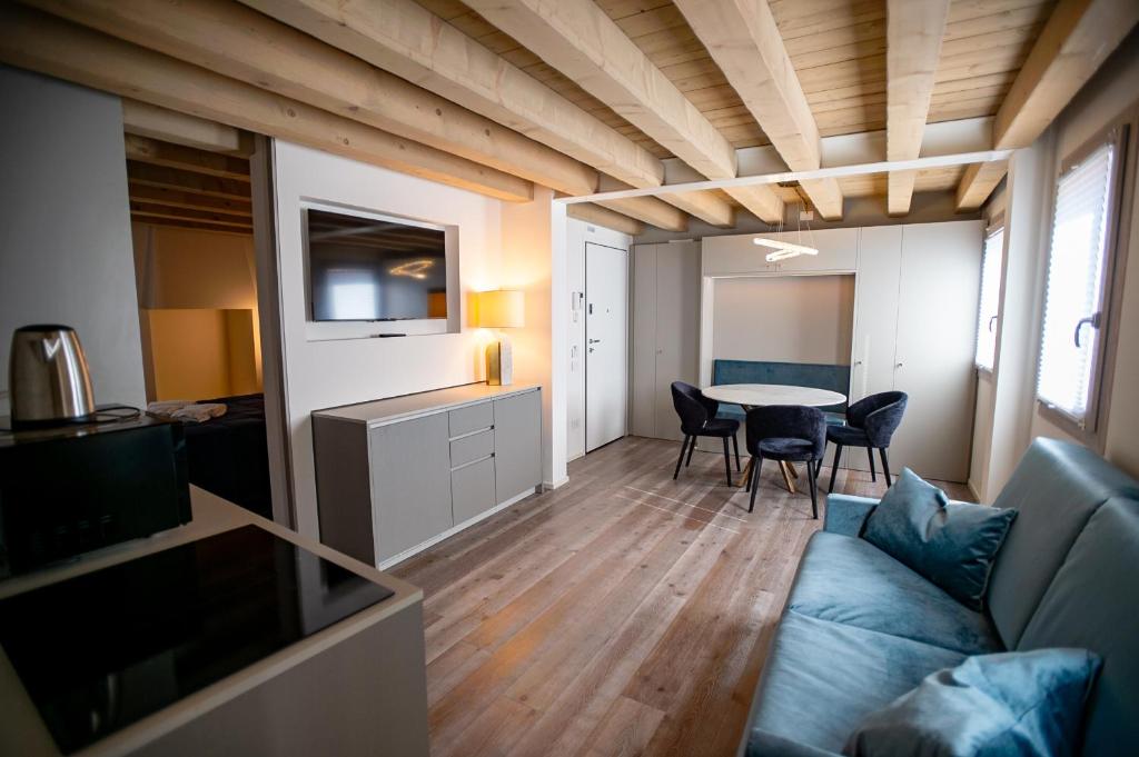 a living room with a blue couch and a table at CA' del SAL LUXURY APARTMENTS in Chioggia