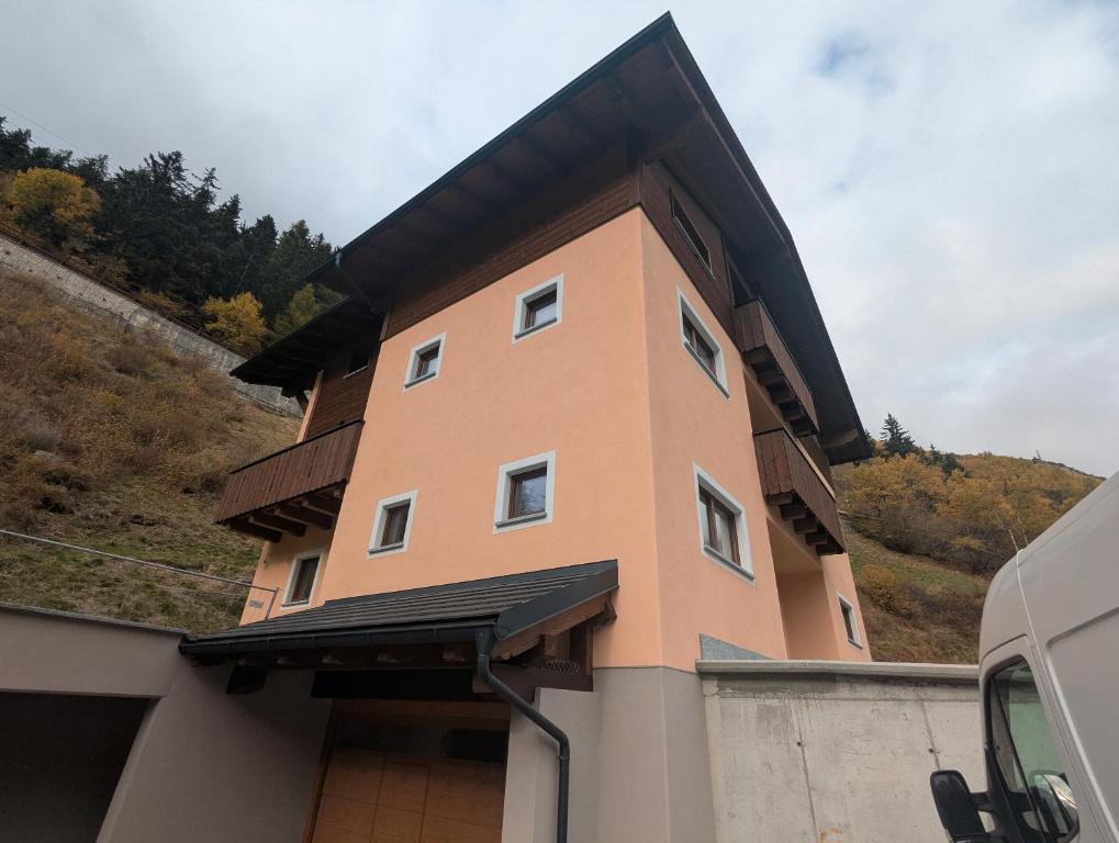 a building with a black roof on top of a garage at Chalet Serenella in Valdidentro