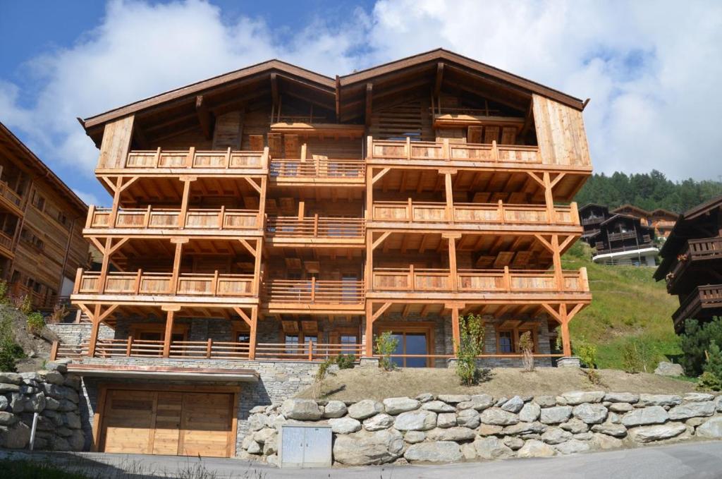 a large wooden building with balconies on a hill at Adelaide A 03 in Grimentz