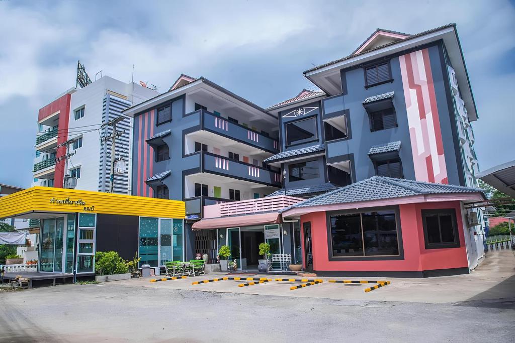 a group of tall buildings with a gas station at Sleep CNX in Chiang Mai