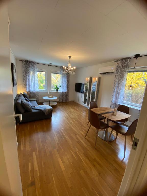 a living room with a couch and a table at Private Villa Suite with Independent Entrance in Täby