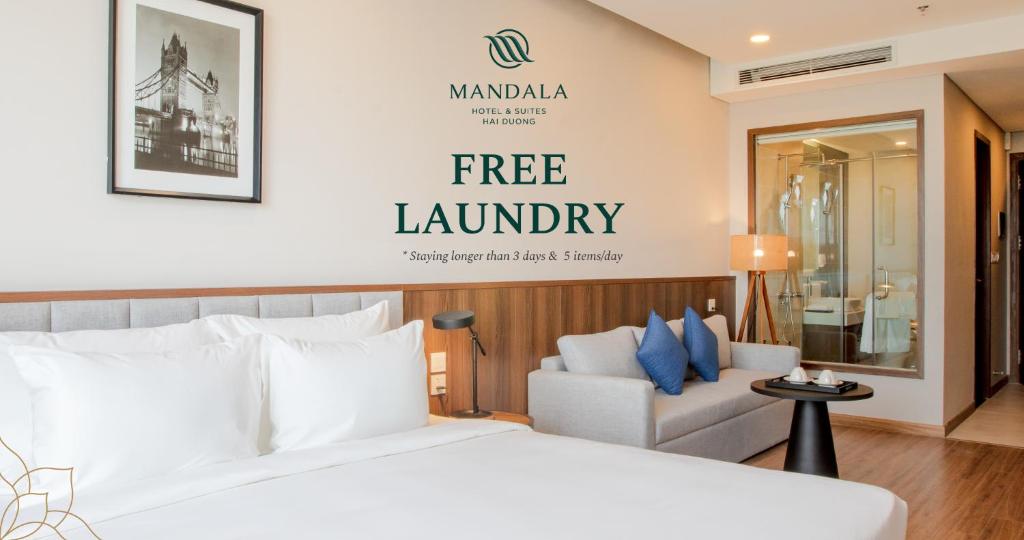 a hotel room with a bed and a free laundry sign at Mandala Hotel & Suites Hải Dương in Bảo Thap