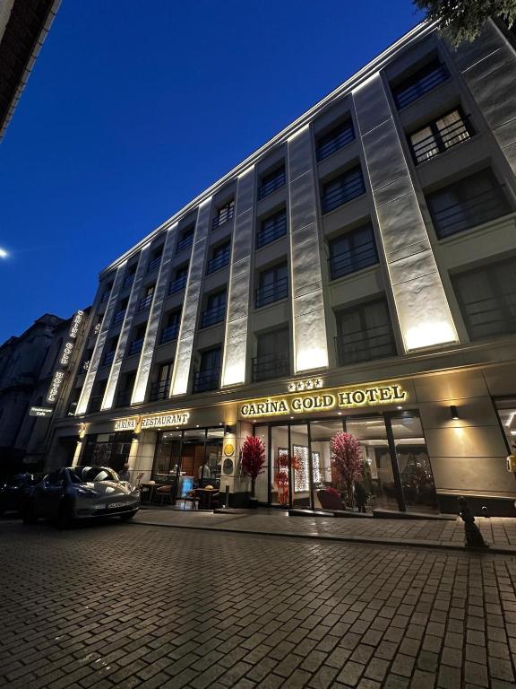 a large building with a car parked in front of it at Carina Gold Hotel And Restaurant in Istanbul