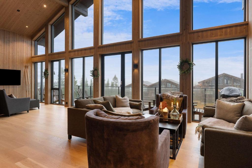 a large living room with a lot of windows at Mountain Chalet 958 by Vacation Trysil in Trysil