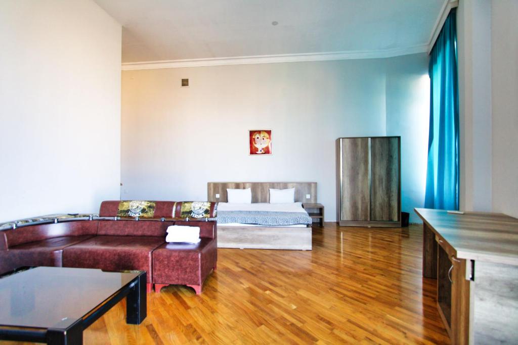 a living room with a bed and a couch at Liman Apartment Nz in Baku