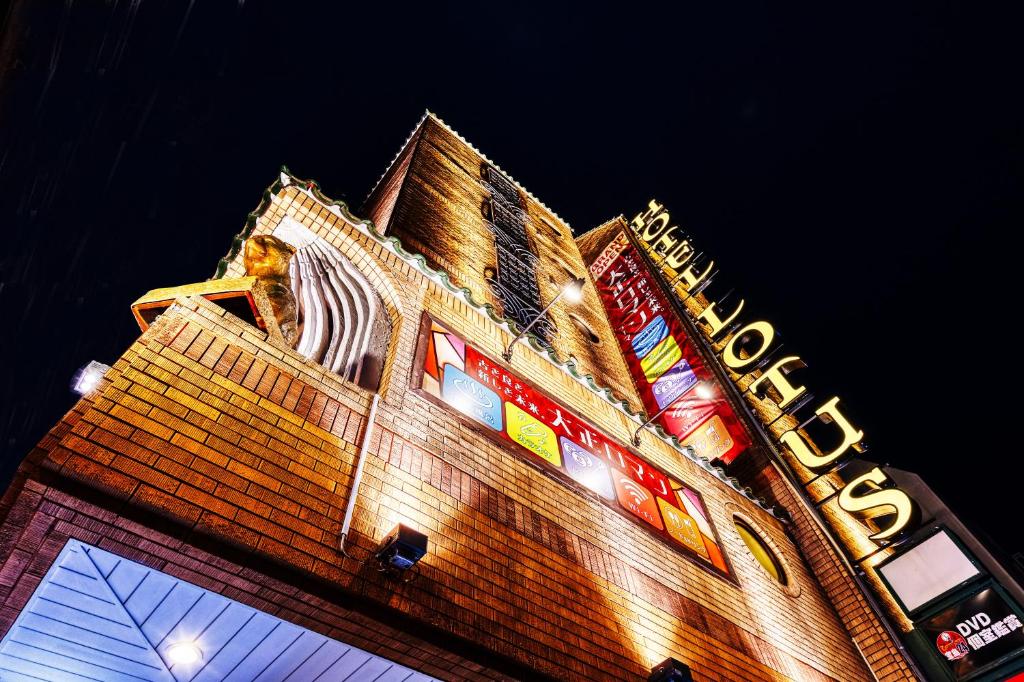 a building with neon signs on the side of it at Hotel Lotus Yokohama in Yokohama